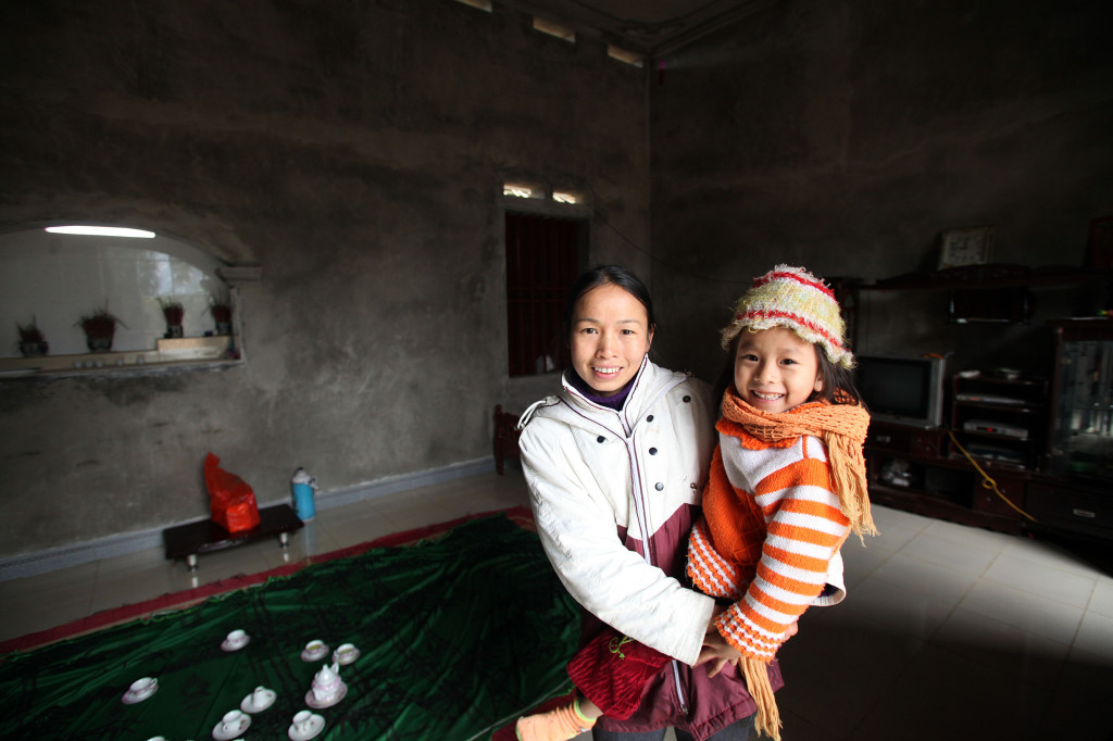 Ma Thi Huong is 35 and a local farmer trainer on pig and sow raising. Through her involvement in the project she participated in training activities and provided with her new techniques which have seen her piglets gain weight faster, contract few diseases and therefore increase her income. With the extra income she has been able to build a new home for her family. Image: Josh Estey/CARE