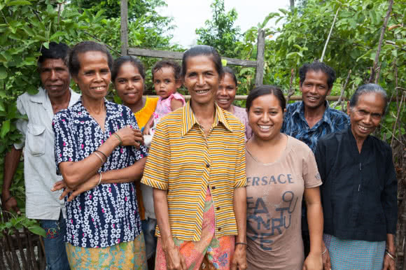 Benvinda (centre) is the leader of a farmer's group CARE is supporting in Timor-Leste. The farmers work together and with the training, improved seed varieties, tools and materials provided by CARE they are able to increase crop yield, earn an income and build their resilience to cope during times of food shortage. Image: Tom Greenwood/CARE.