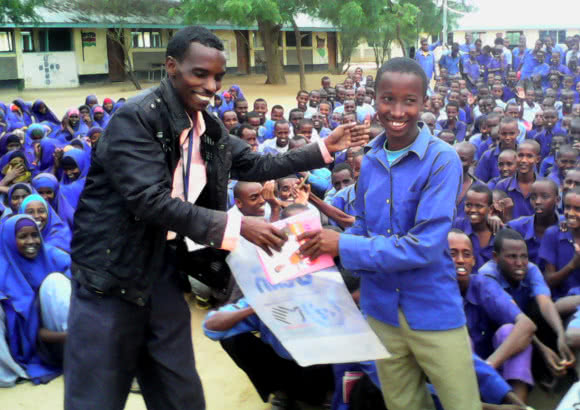 Hassan with students at a CARE ran school in the Dadaab refugee camp, Kenya