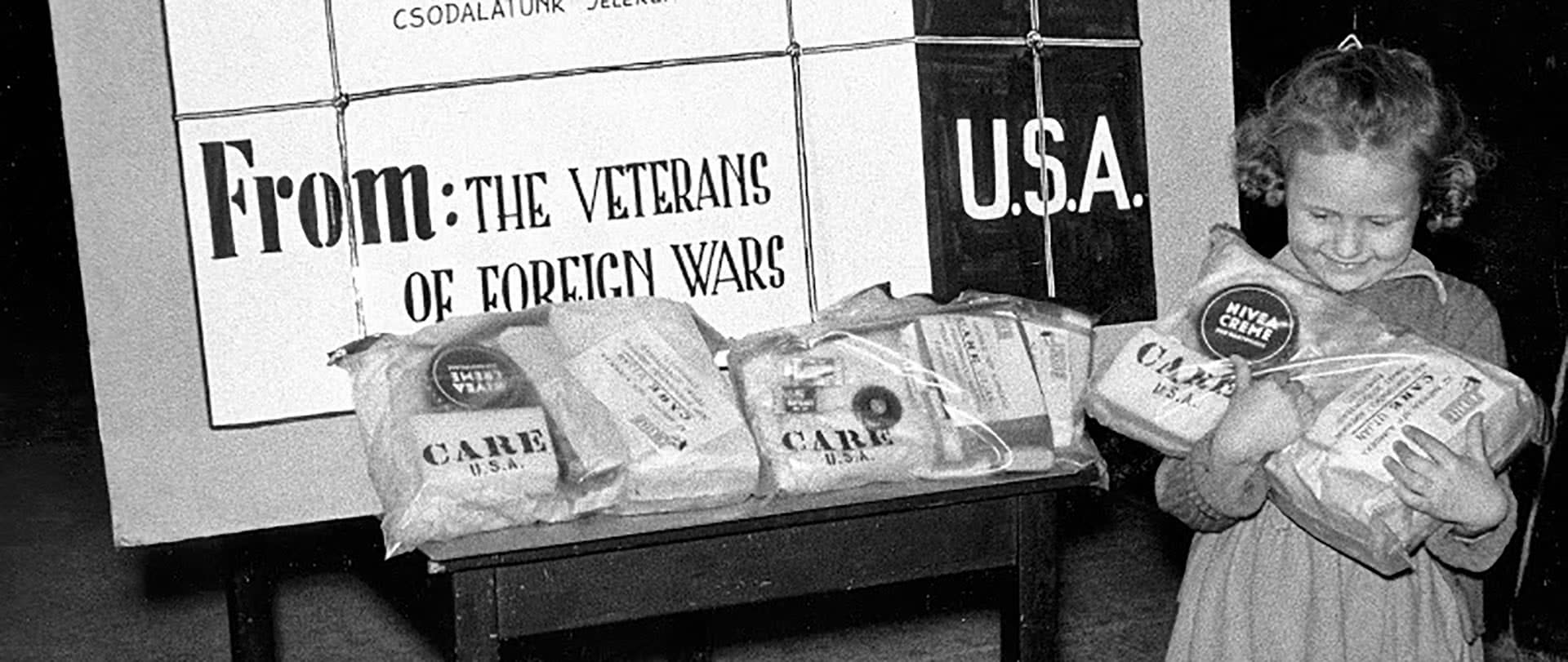 A girl receives CARE packages on courtesy of the Veterans of Foreign Wars.