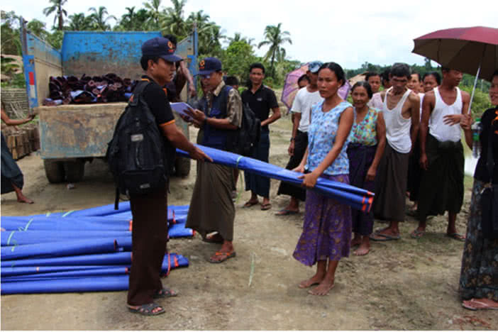 Communities affected by the Myanmar floods receive tarpaulins.