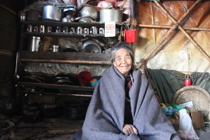 preparing-for-harsh-winter-in-nepal-woman-sitting-in-tent