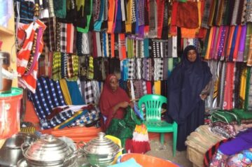 Damac, 40 (left) and Habibo, 35 (right), started their clothing shop after joining a VSLA is Somalia. Photo © Wanjiru Wambugu/CARE